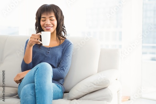 Smiling casual woman drinking coffee