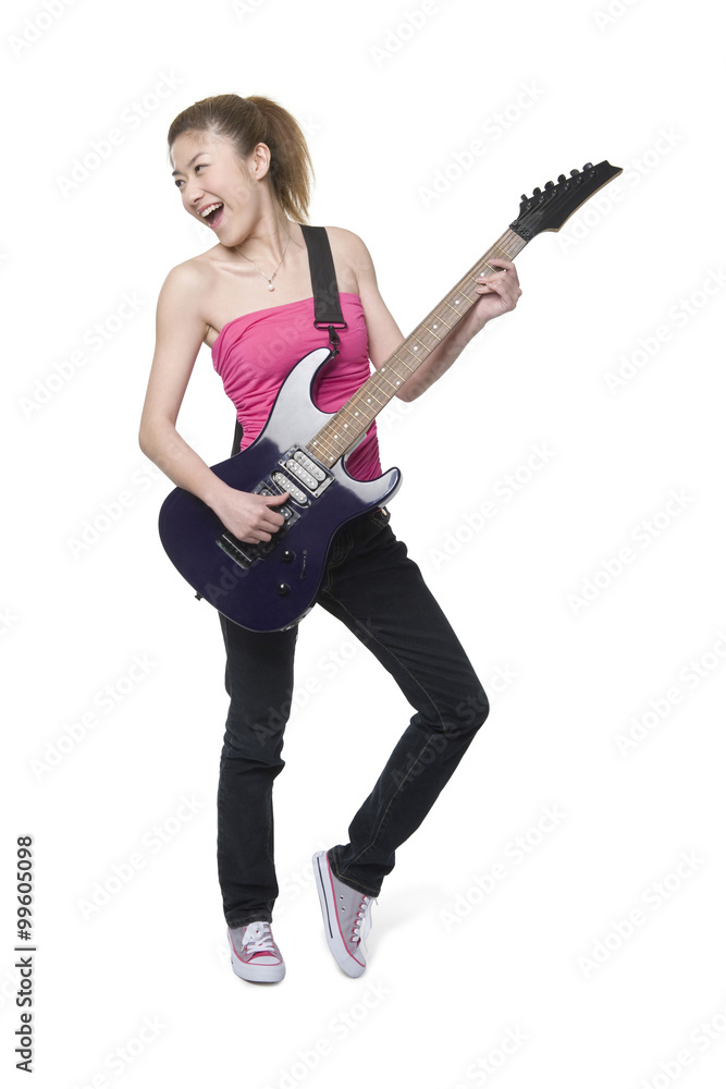 Young woman playing an electric guitar