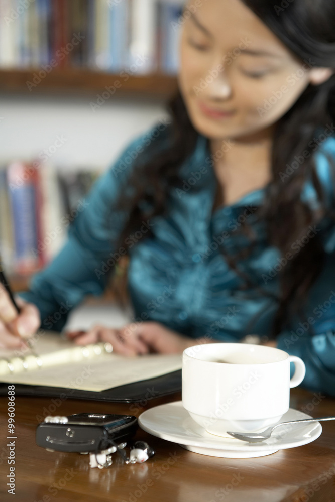 Businesswoman Writing In A Book