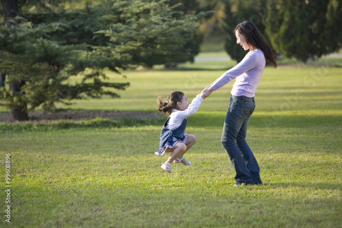 Mother and daughter playing in the park