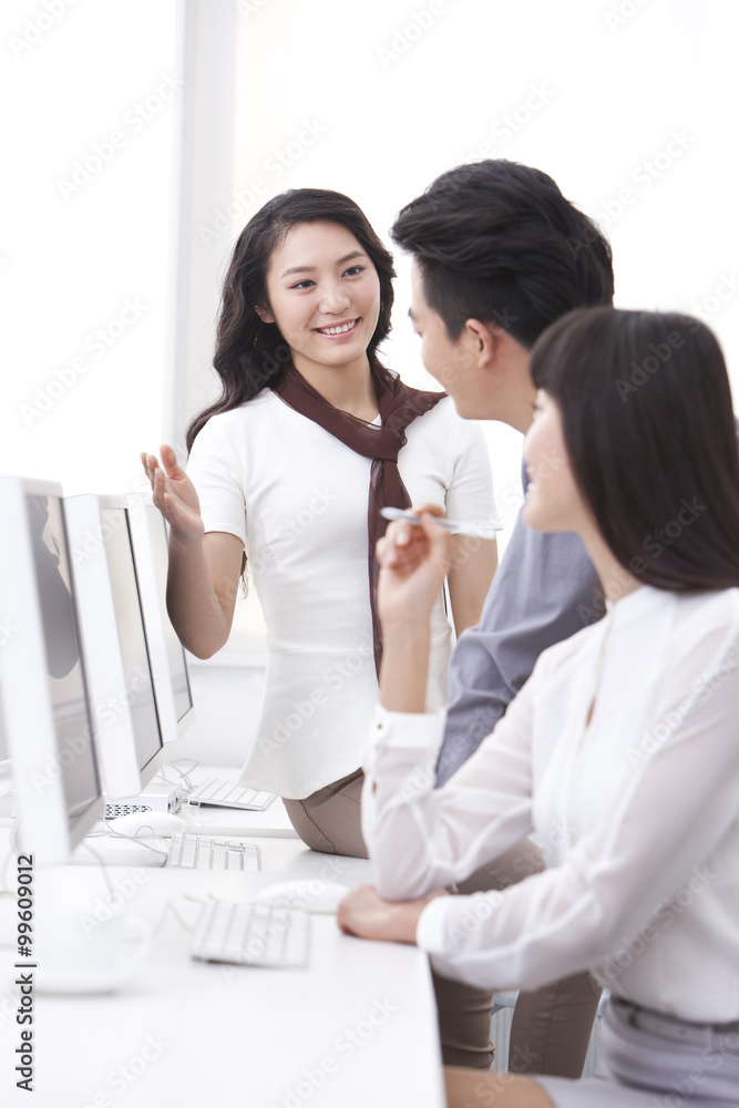 Cheerful white collar workers using computers in office Cheerful white collar workers using computers in office
