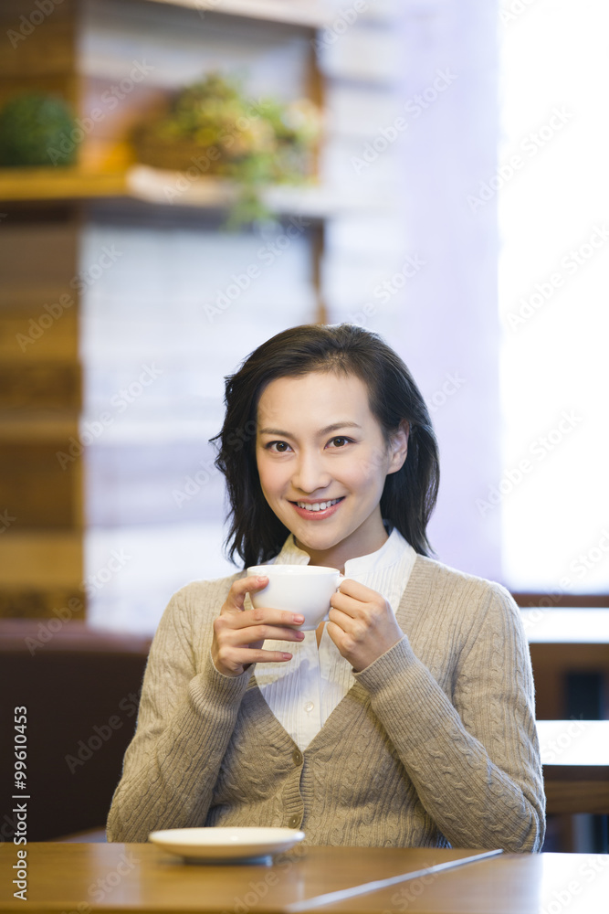 Young woman having coffee in cafe Young woman having coffee in cafe