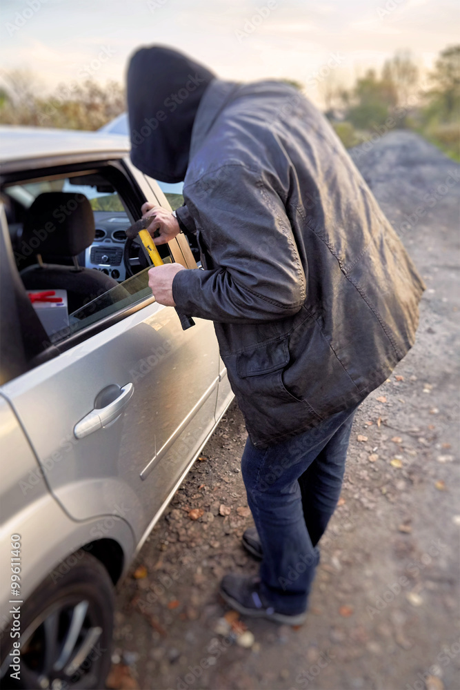 Hooligan breaking into car Hooligan breaking into car