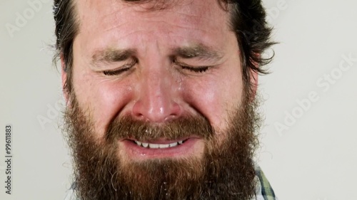 Extreme close up of hipster crying against neutral background