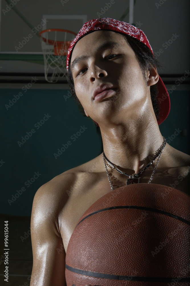 Topless Young Man Holding Basketball Stock Photo | Adobe Stock