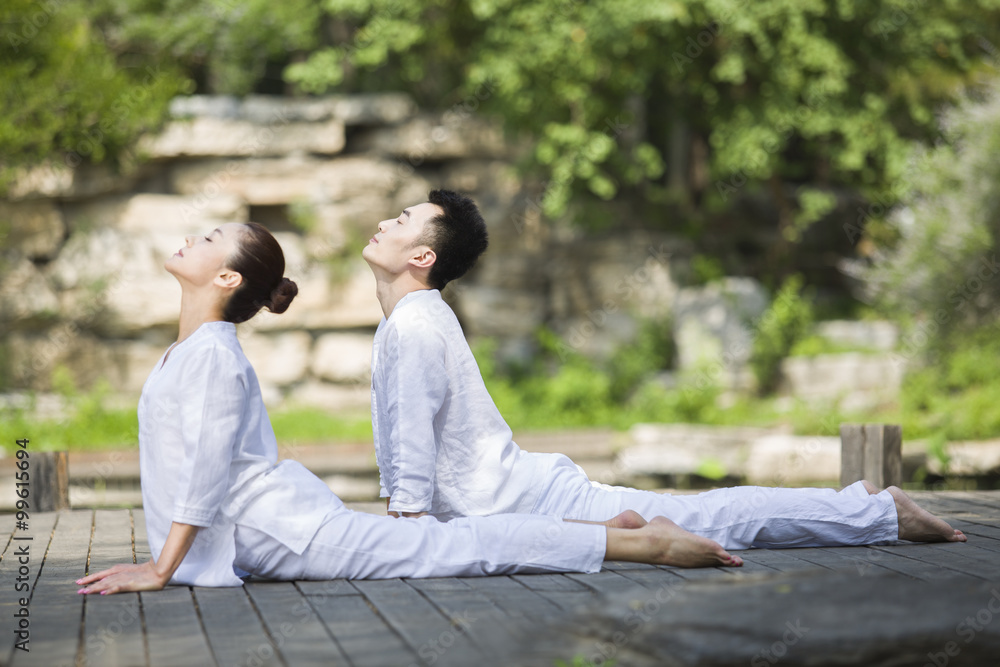 Young couple practicing yoga