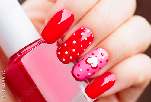 Valentines Day holiday style bright manicure with painted hearts and polka dots