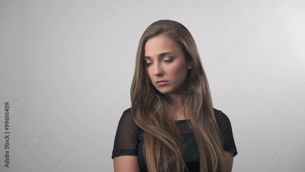 Portrait of sad depressed girl thinking about something.Pretty woman posing for the camera on white background Portrait of sad depressed girl thinking about something.Pretty woman posing for the camera on white background