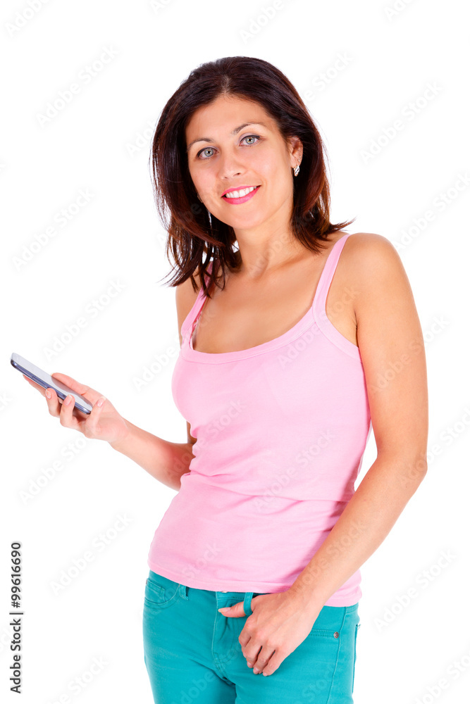 Portrait of slim smile brunette tanned woman with short hairstyle, dressed in t-shirt and jeans, hold cell mobile phone in hand and looking to camera. Isolated on white background. Positive emotion
