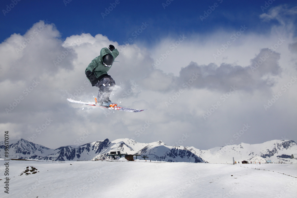 Flying skier on mountains. Extreme sport.