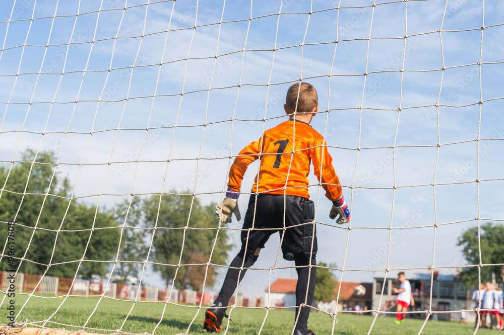 Naklejka premium little soccer goalkeeper