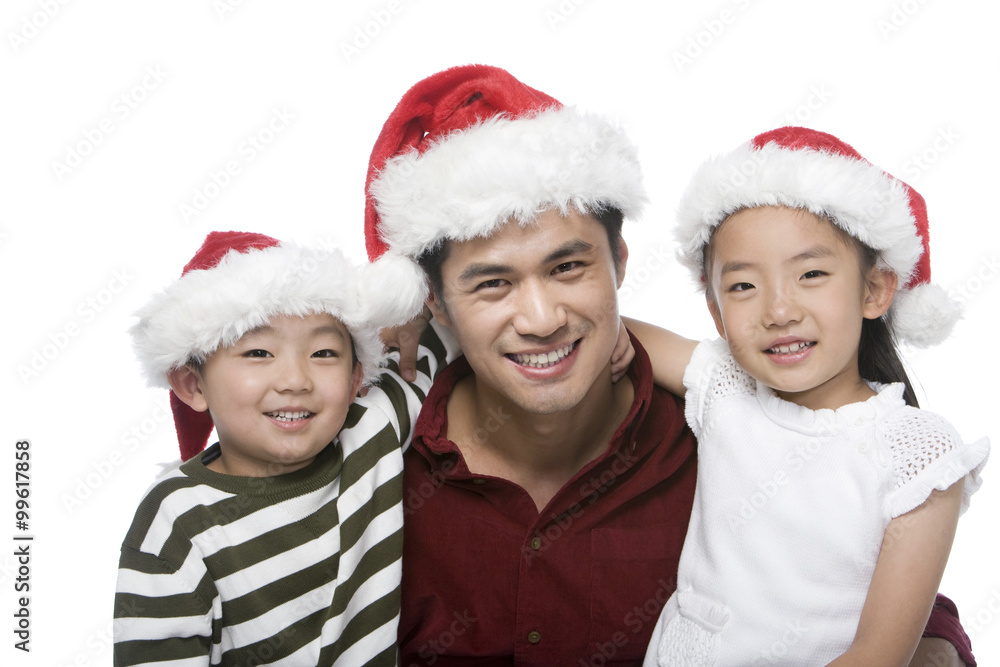 Father and children with Santa hats Father and children with Santa hats