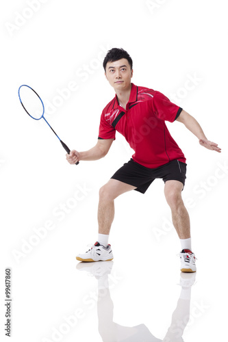 Male athlete playing badminton © Blue Jean Images