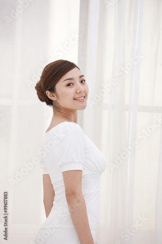 Free Download Young woman looking calm by the window - GFXLoad
