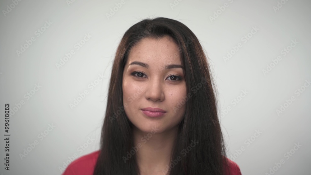 Portrait of pretty young Asian woman smiling at the camera.Closeup portrait.Beautiful woman posing for the camera on white background Portrait of pretty young Asian woman smiling at the camera.Closeup portrait.Beautiful woman posing for the camera on white background