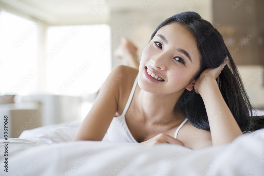 Young woman lying on bed Young woman lying on bed