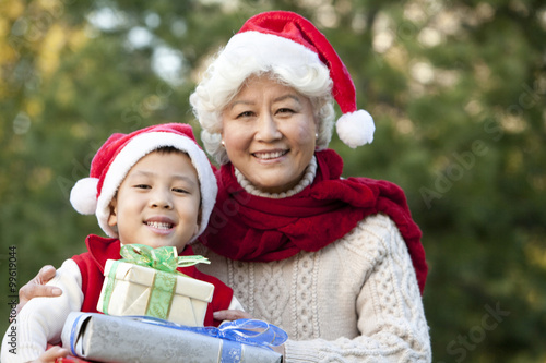 Grandmother and Grandson Holding Christmas Gifts