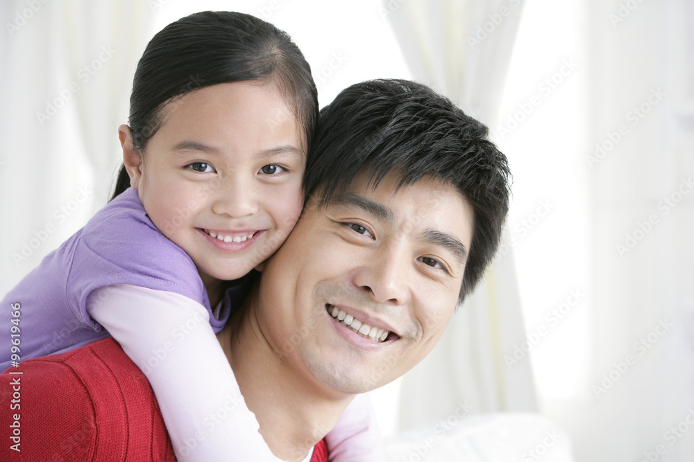 Chinese daughter embracing father from behind Chinese daughter embracing father from behind