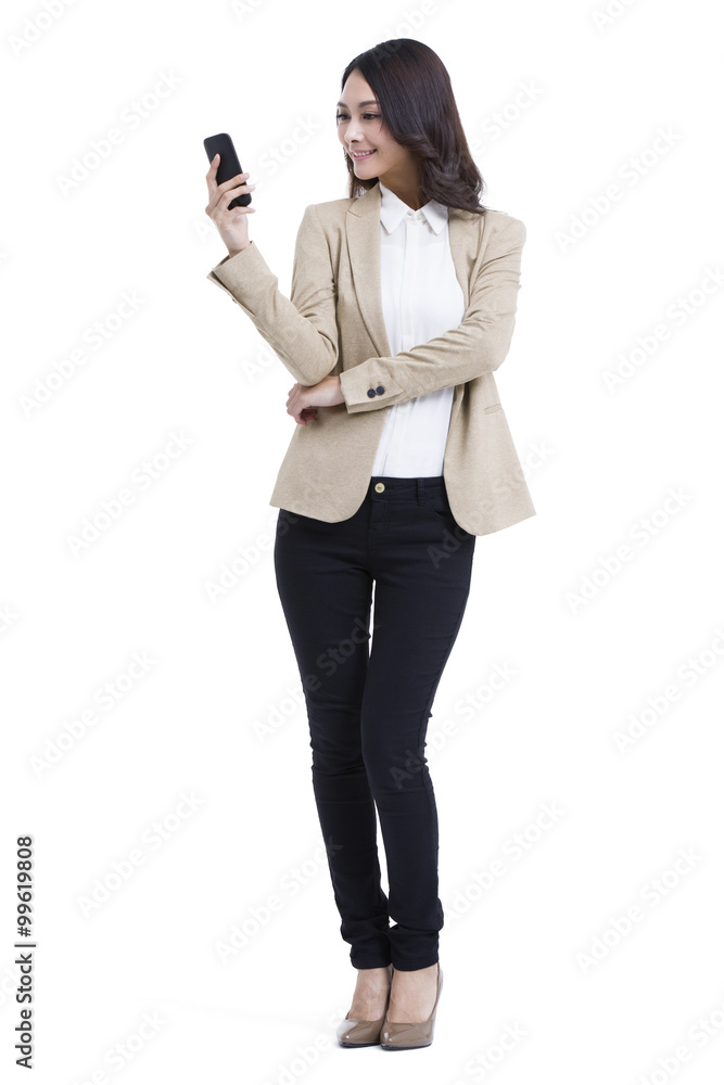Fashionable businesswoman texting message Fashionable businesswoman texting message