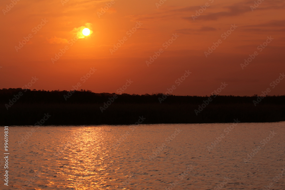 Naklejka premium Brilliant orange sunrise over clouds.
