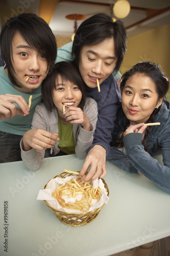 Teenagers Sharing French Fries