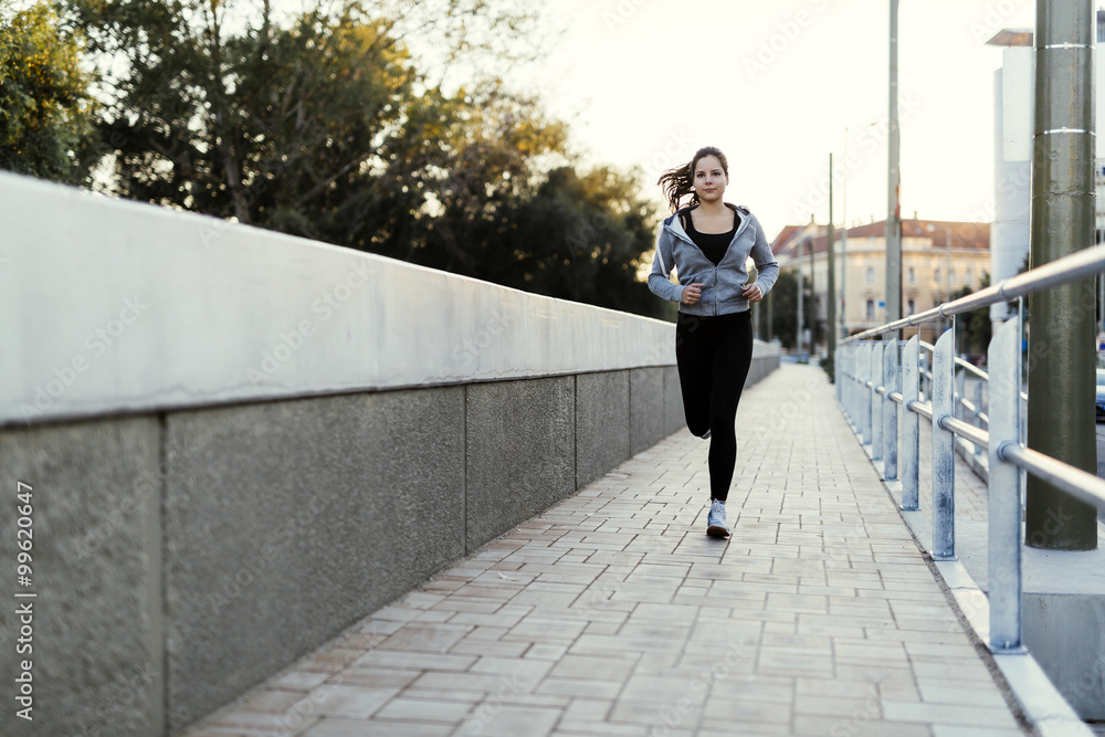 Sporty woman jogging in city