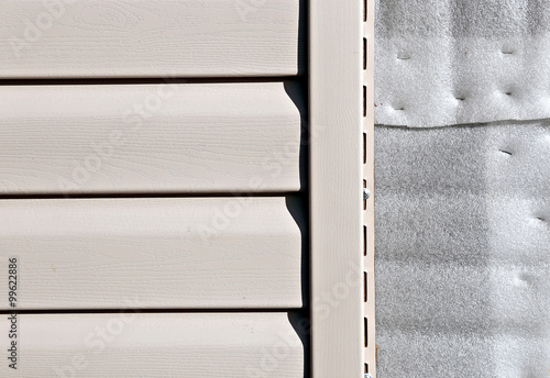 Installation on facade panels beige vinyl siding