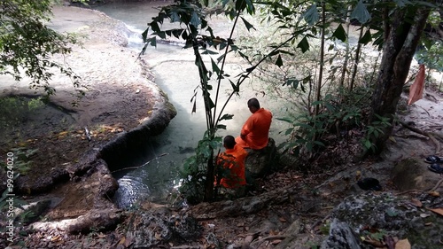 Monks near the water in Asia