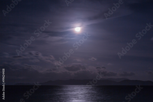 Fotografie Full moon with clouds and sky over the sea