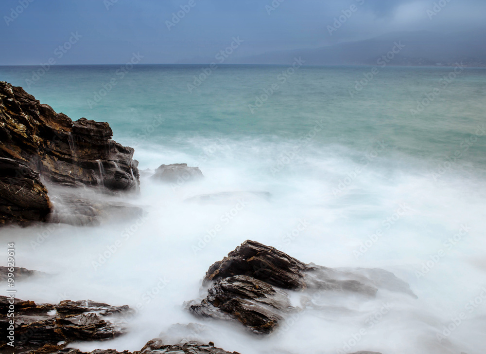 rough sea with stormy weather in the background