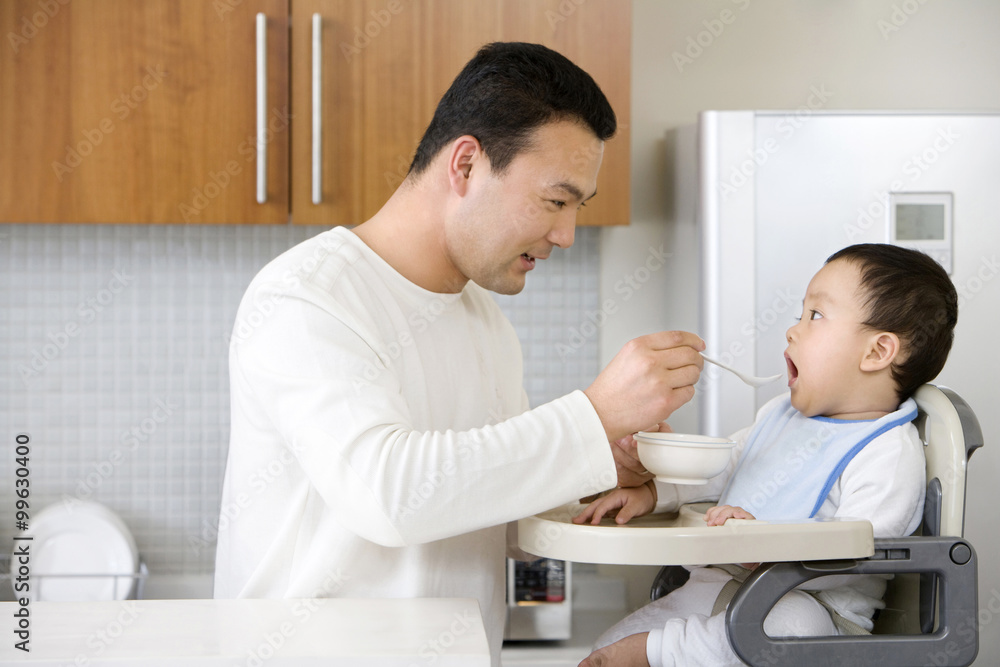 Man feeding infant Man feeding infant
