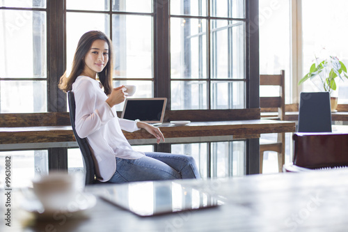Young woman drinking coffee in cafe Free Download Young woman drinking coffee in cafe - GFXLoad