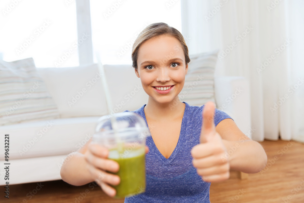 happy woman with cup of smoothie showing thumbs up happy woman with cup of smoothie showing thumbs up