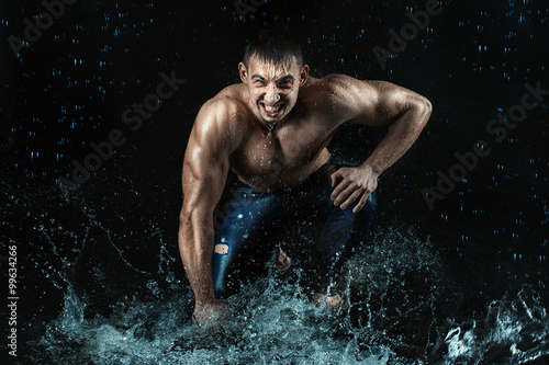 Man with athletic figure struck the water.