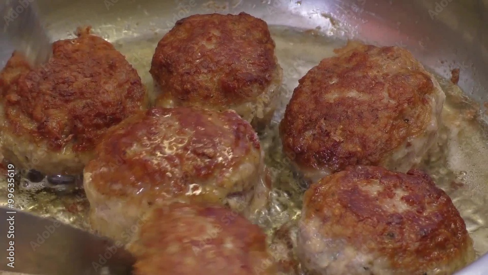 patties of minced meat in a frying pan fried in oil
patties of minced meat in a frying pan fried in oil