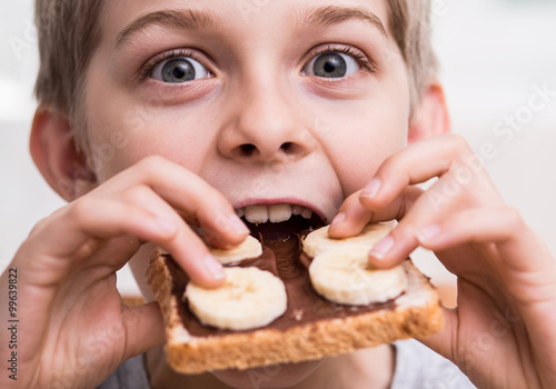 Boy eating sandwich with chocolate