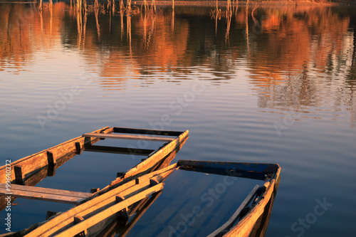 Fotografie Old wooden fishing boat on a lake