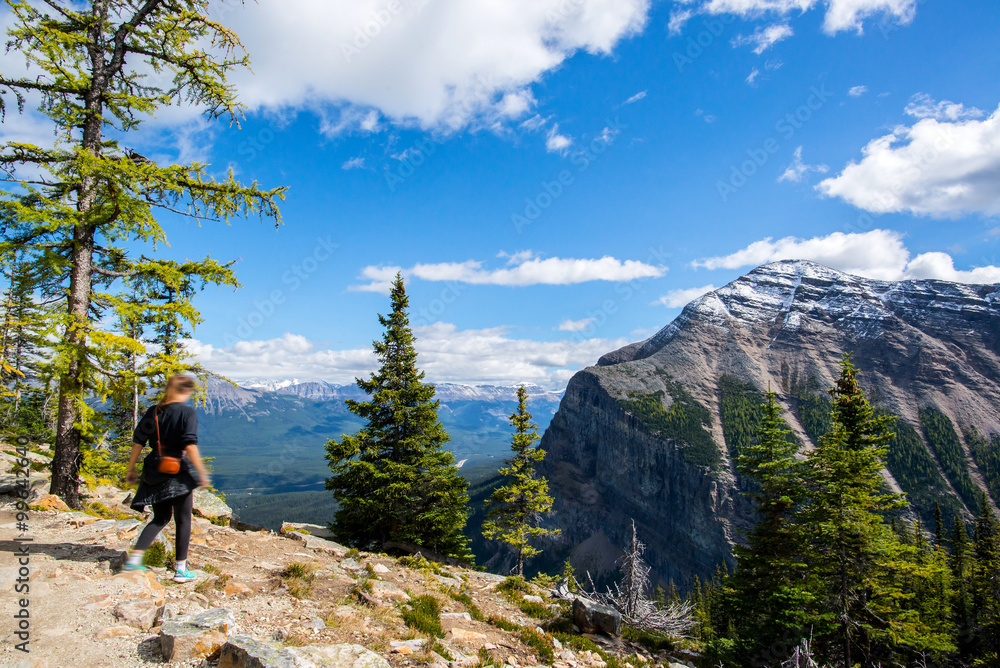 girl walking on a summit of a mountain in the banff national park in alberta canada close to lake louise