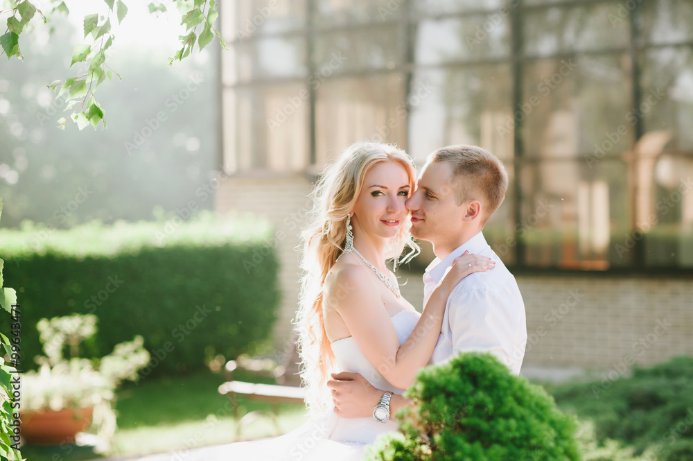Naklejka premium Sensual embrace bride and groom in the light of sunset, relationships, family, wedding