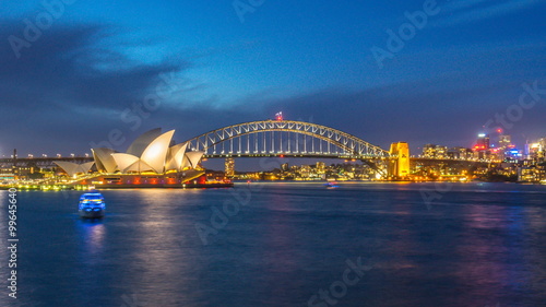 4k footage time lapse of day to night blue hour at Sydney Opera House, view from Royal Botanic Gardens. Panning