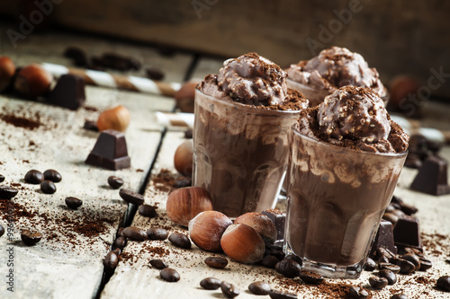 Chocolate-Coffee dessert with whipped cream, nuts and chocolates