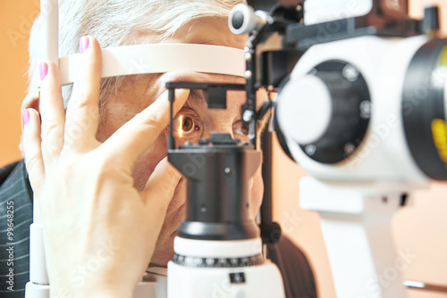 male patient under eye sight examination at ophthalmology clinic photo