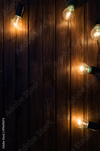 Wallpaper Mural Light bulbs on dark Wooden Background Torontodigital.ca