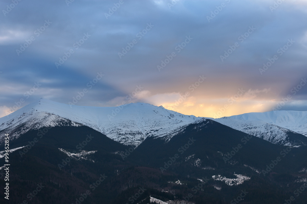 Sunset over winter mountain ridge