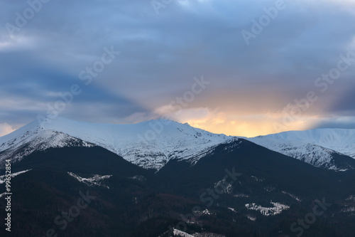 Sunset over winter mountain ridge