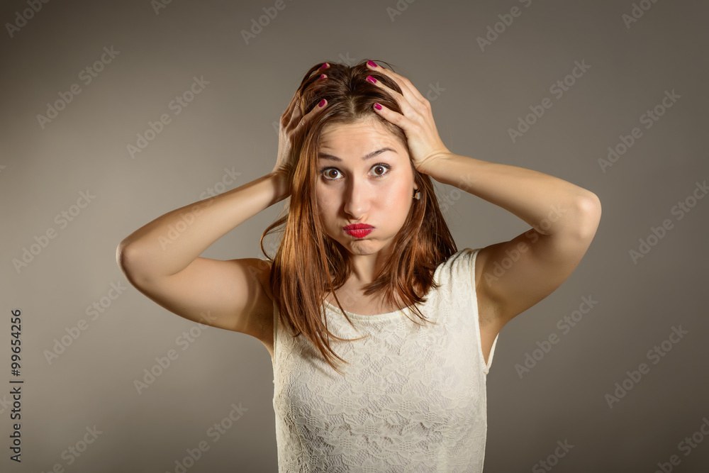 Naklejka premium Closeup portrait displeased, pissed off, angry, grumpy, pessimistic, woman with hands on head with bad headache. Negative human emotions face expression feelings life perception