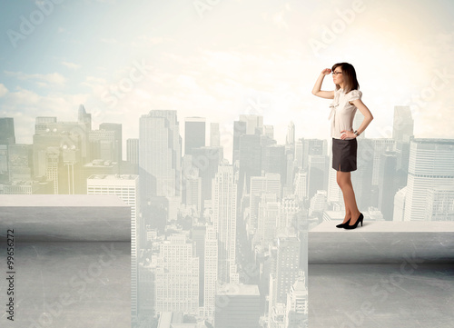 Businesswoman standing on the edge of rooftop