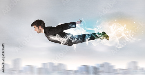 Wallpaper Mural Hero superman flying above city with smoke left behind Torontodigital.ca