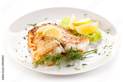 Slika na platnu Fish dish - fried fish fillet and vegetables