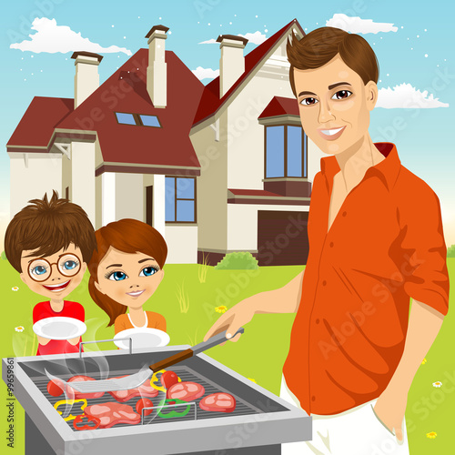 young happy father barbecuing meat on the grill